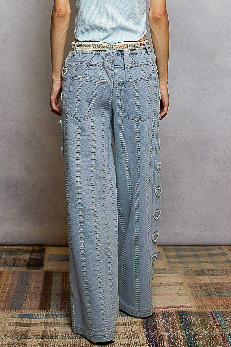 Textured denim side heart patch accents woven pants