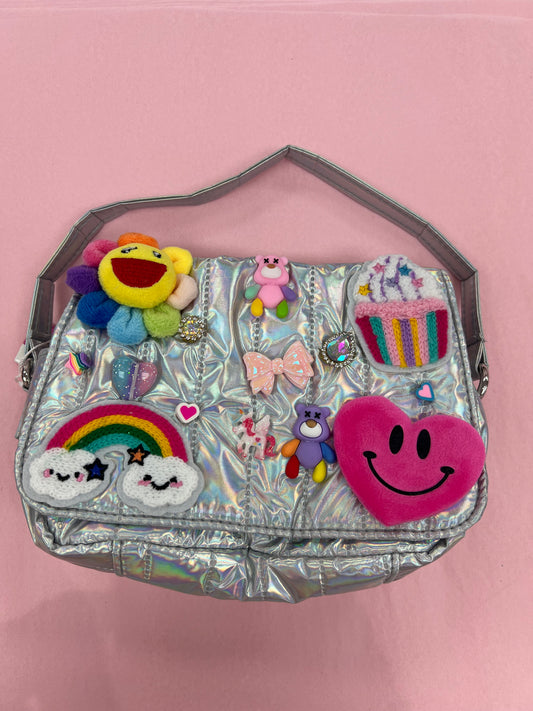 Quilted charm cross body bag in silver